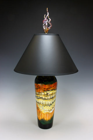 Decorative lamp with a black shade and multicolored base on a gradient background